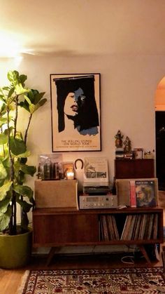 a living room filled with furniture and a large poster on the wall over a record player