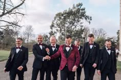 a group of men in tuxedos standing next to each other