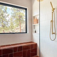 a bathroom with a large window and tiled walls