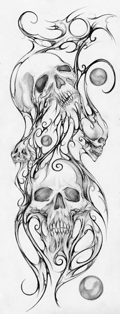 a drawing of skulls and swirls on paper