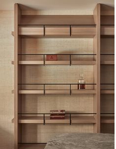 an empty book shelf in the corner of a room with books on it and a table next to it