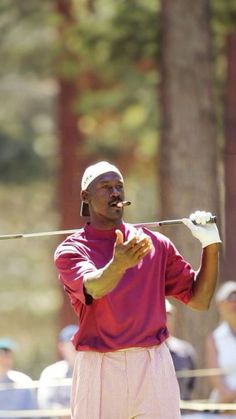 a man holding a golf club in his right hand