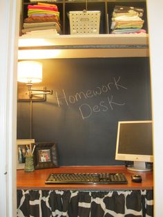 a desk with a computer on top of it in front of a chalkboard that says homework desk