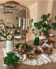 a table topped with lots of different types of food and candles on top of it