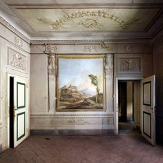 an empty room with paintings on the walls