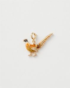 a small bird charm on a white background