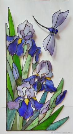 a stained glass panel with blue flowers and a dragonfly flying over the irises