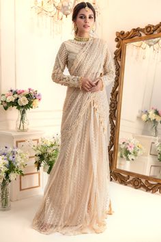 Taking inspiration from Ornamental art, this stunning Lehenga saree features monotonal threadwork further enhanced with pearls, sequins, crystals, beads and Swarovski stones. This look is completed with embroidered pleated flowy lehenga & embellished embroidered net stylized dupatta which can be hooked and worn as per your comfort creating gorgeous saree silhouette making it an ideal choice for any celebratory occasion. Fabric: Embroidered NetColor: Beige This is a made to measure look, once ord Flowy Lehenga, Saree Silhouette, Gorgeous Saree, Ornamental Art, Bridal Maxi, Before And After Pics, Sarees For Girls, Designer Outfit