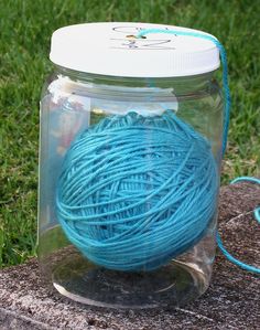 a ball of yarn in a jar on the ground