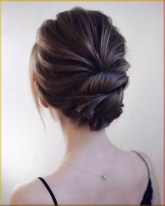 a woman with her hair in a low bun