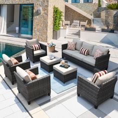 an outdoor living area with couches, tables and chairs near a swimming pool in the background