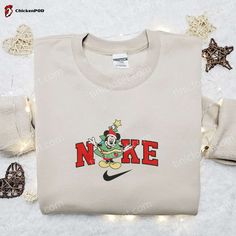 Get into the festive spirit with the Nike x Christmas Tree Mickey Cartoon Embroidered Sweatshirt! This unique sweatshirt features a delightful Mickey Mouse cartoon embroidered on the front, surrounded by a vibrant Christmas tree design. Made from high-quality materials, it offers both comfort and durability. The sweatshirt is perfect for Disney lovers and makes a great gift for Christmas. Stand out from the crowd and spread holiday cheer with this merry and stylish sweatshirt. Order now and make Luxury Logo Sweatshirt For Winter, Luxury Winter Sweatshirt With Embroidered Logo, Luxury Hoodie Sweatshirt With Embroidered Logo, Luxury Embroidered Logo Hoodie Sweatshirt, Disney Christmas Minnie Red Head Sweatshirt, Nike Cartoon, Disney Character Shirts, Nike Inspired, Timmy Turner