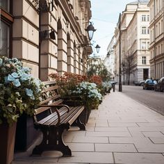 a wooden bench sitting on the side of a building next to flowers and plants in front of it