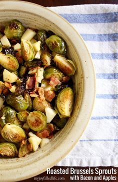 roasted brussel sprouts with bacon and apples in a bowl on a towel