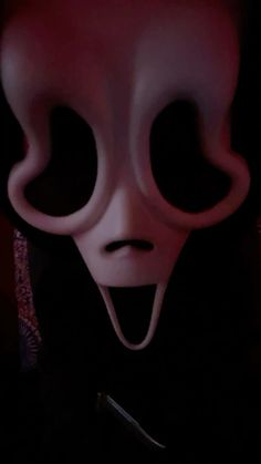 a creepy mask is shown in the dark