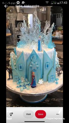 there is a cake that looks like it has frozen castle on top and frosted with icing