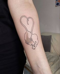 a woman's arm with a small tattoo of a rat on the back of her arm