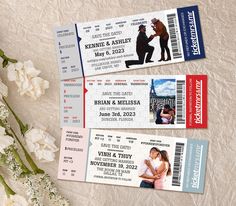 three tickets sitting on top of a table next to white flowers and vase with flowers in it