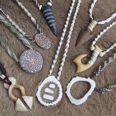 several different necklaces are laid out on a fur surface