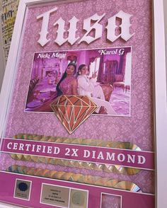 a framed poster with the name and image of two women in front of a diamond