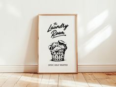 a framed poster with the words laundry room on it in front of a white wall