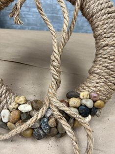 two rope wrapped wreaths with rocks on them