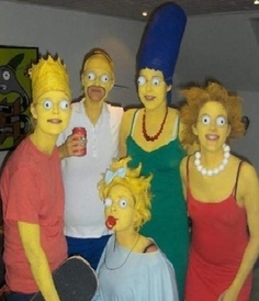 a group of people dressed up as simpsons posing for a photo with one person holding a skateboard