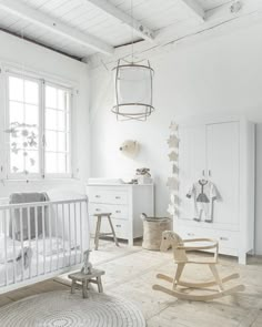 a baby's room with a rocking chair, crib and other furniture in it