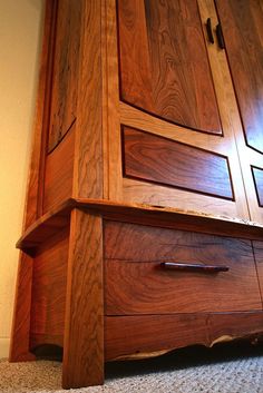 a close up of a wooden cabinet on the floor