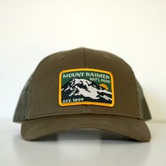 Our amazing vintage Mount Rainier National Park vintage patch is now on a sweeeet olive colored trucker cap! Classic snapback Every purchase helps support the National Parks via organizations like WNPF.org Finished in the PNW Vintage Patch of amazing quality (you can feel The Mountain on it!) Mesh Back-Ultimate Breathability Patch designed by the legend Phill Monson Closure: Snapback Curved Brim Trucker Hat For Baseball Season, Six-panel Trucker Hat For Baseball Season, Baseball Season Trucker Hat With Flat Bill For Outdoor, Baseball Season Trucker Hat With Flat Bill, Outdoor Trucker Hat For Baseball Season, Flat Bill Trucker Hat For Baseball Season, Breathable Outdoor Hat For Baseball Season, Adjustable Snapback Trucker Hat For Outdoor, Adjustable Fit Snapback Trucker Hat For Outdoor