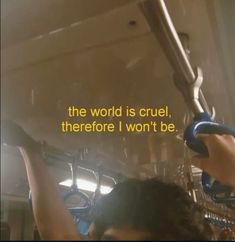 a woman is holding onto the handle of a bus with a quote on it that reads, the world is cruel, there's won't be