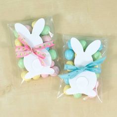 two plastic bags filled with easter decorations on top of a table