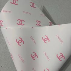 two white envelopes with pink chanel logos on them