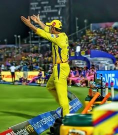 a man in yellow uniform standing on top of a field