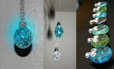 three different colored glass pendants hanging from chains