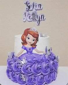 there is a cake that has been decorated with purple flowers and a princess sitting on top