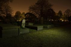 a cemetery at night with the lights on