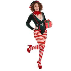 a woman dressed in christmas clothing and stockings is running while holding a gift box with both hands