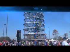 a large metal structure sitting in the middle of a crowd