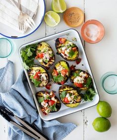 an overhead view of some food on a tray with utensils and plates next to it