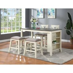 a kitchen table with four stools in front of it