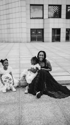 two women sitting on the ground with their babies