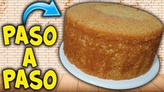 a cake sitting on top of a white plate next to a brick wall with the words paso a paso