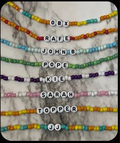 multicolored beaded name necklaces with white letters on each strand and the word'odbx, raae, john b pope, kre, kale, sarah topper,