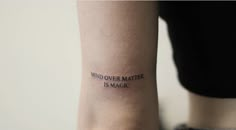 a woman with a tattoo on her arm that says mind over matter, is magic