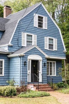 a blue house with white trim and windows