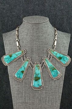 This vintage and intricately crafted Turquoise Mountain turquoise and sterling silver necklace, earrings, bracelet and ring set was made by Navajo silversmith Oliver Smith. The set is signed O. Smith and stamped .925.Necklace: 18"Length: 2 5/8"Width: 1 1/8"Earrings:Length: 1 3/8"Width: 3/4"Ring:Size: 10.5Length: 1 1/4"Width: 1"Bracelet:Size: 5 1/4" (fit for a 6 3/4" wrist)Gap: 1 1/2"Length: 1 3/4"Free shipping on all orders! We ship with USPS and always include tracking. All orders ship within a One Of A Kind Southwestern Turquoise Jewelry, Southwestern Turquoise Sterling Silver Jewelry, Antique Untreated Sterling Silver Jewelry, Untreated Turquoise Jewelry For Jewelry Making, Southwestern Style Turquoise Jewelry In Sterling Silver, Antique Turquoise Jewelry For Jewelry Making, Antique Turquoise Gemstone Jewelry, Southwestern Style Turquoise Sterling Silver Jewelry, Bohemian Hallmarked Collectible Jewelry