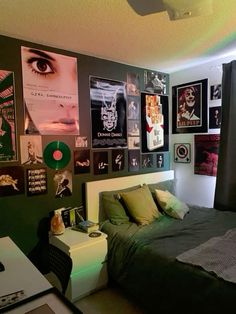 a bedroom with posters on the wall and a bed