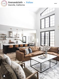 a living room filled with furniture and lots of windows