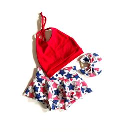 Fourth of July stars printed skirted Bummie with matching bow and red crop halter top Halter - Made with cotton/spandex fabric, double brushed polyester (DBP) Skirted Bummie and Bow - made with Liverpool/bullet fabric  Feel free to request any other color/print seen in the shop.   Please select from the following sizes: Newborn  0-3 months 3-6 months 6-9 months 9-12 months 12-18 months 18-24 months 2T 3T 4T All sizes are approximate. Please size up or down if you need to. For the most accurate fit, send me your waist and chest measurements in the note to seller box during checkout. *Please note, pattern placement will vary, and colors may vary on different monitors. All items are handmade by me. Please see announcements for current shipping times. All items are shipped by USPS First class Red Stretch Sets For The Beach, Red Cotton Halter Top For Summer, Red Stretch Beach Sets, Red Summer Holiday Sets, Red Stretch Beachwear Sets, Playful Red Fitted Sets, Playful Red Fitted Set, Playful Fitted Red Sets, Summer Red Cotton Halter Top